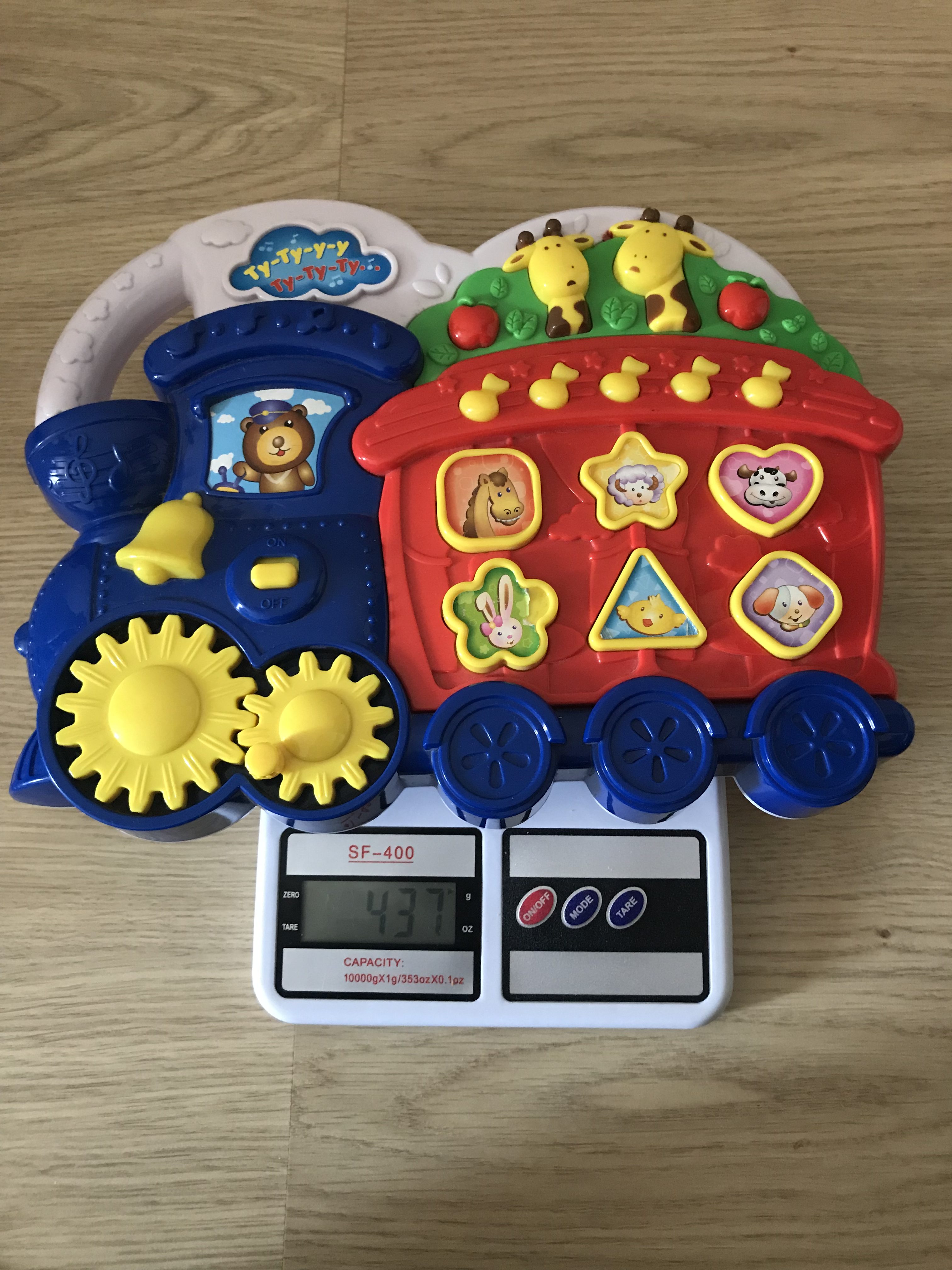 How much does a children's musical toy weigh (without batteries)?