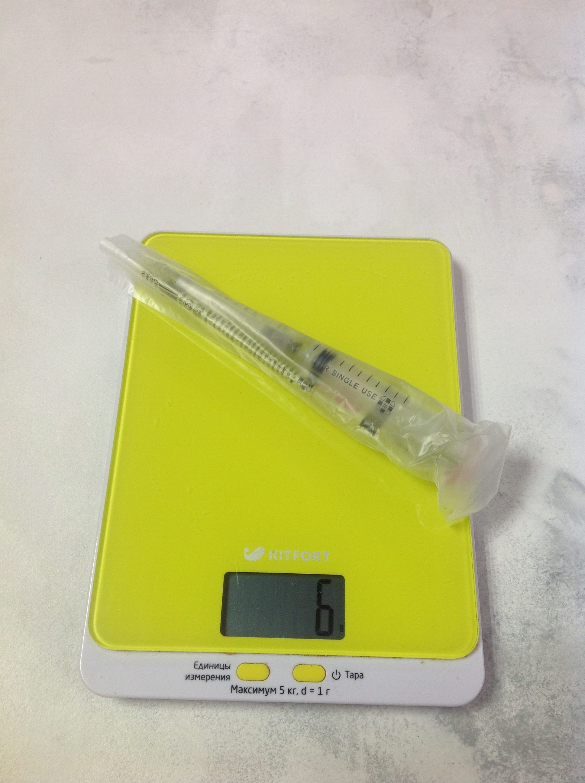 How much does a five-cc syringe weigh in a package?