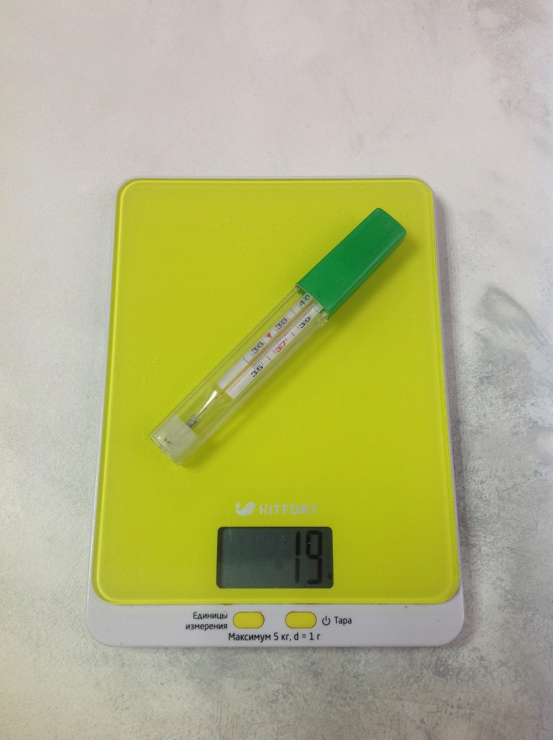 How much does a mercury thermometer (thermometer) weigh in a holder?